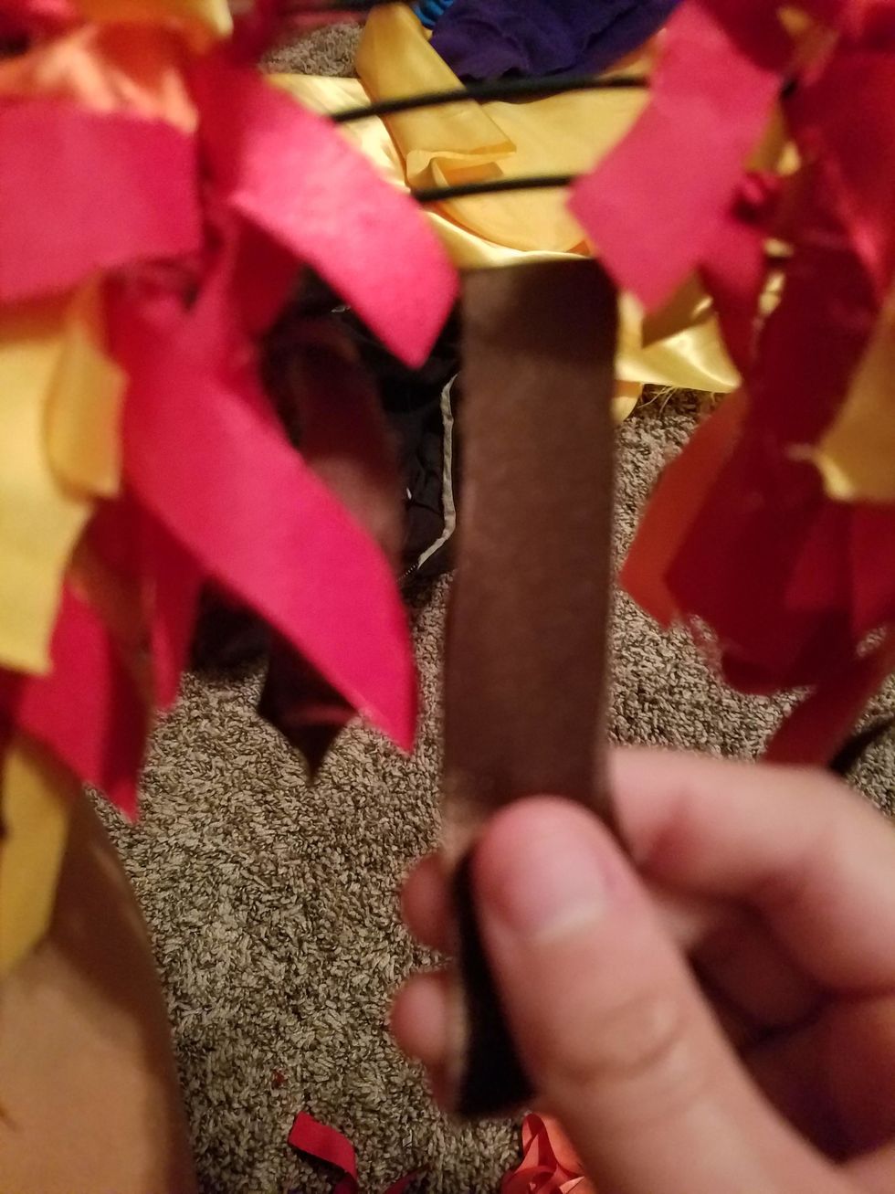 Take a piece of your fabric and put it through the wreathe outline so that there is half of the strip on both sides