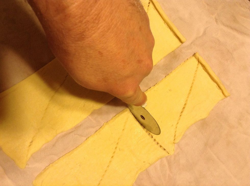 Take a pizza cutter and cut the two halves into half again...