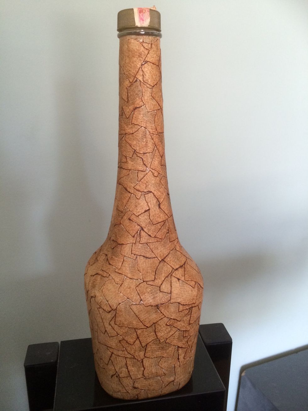 Take a rag or sheet of toweling and apply the shoe polish to the whole bottle. You can spray the bottle with a polyurethane, but that's not absolutely necessary.