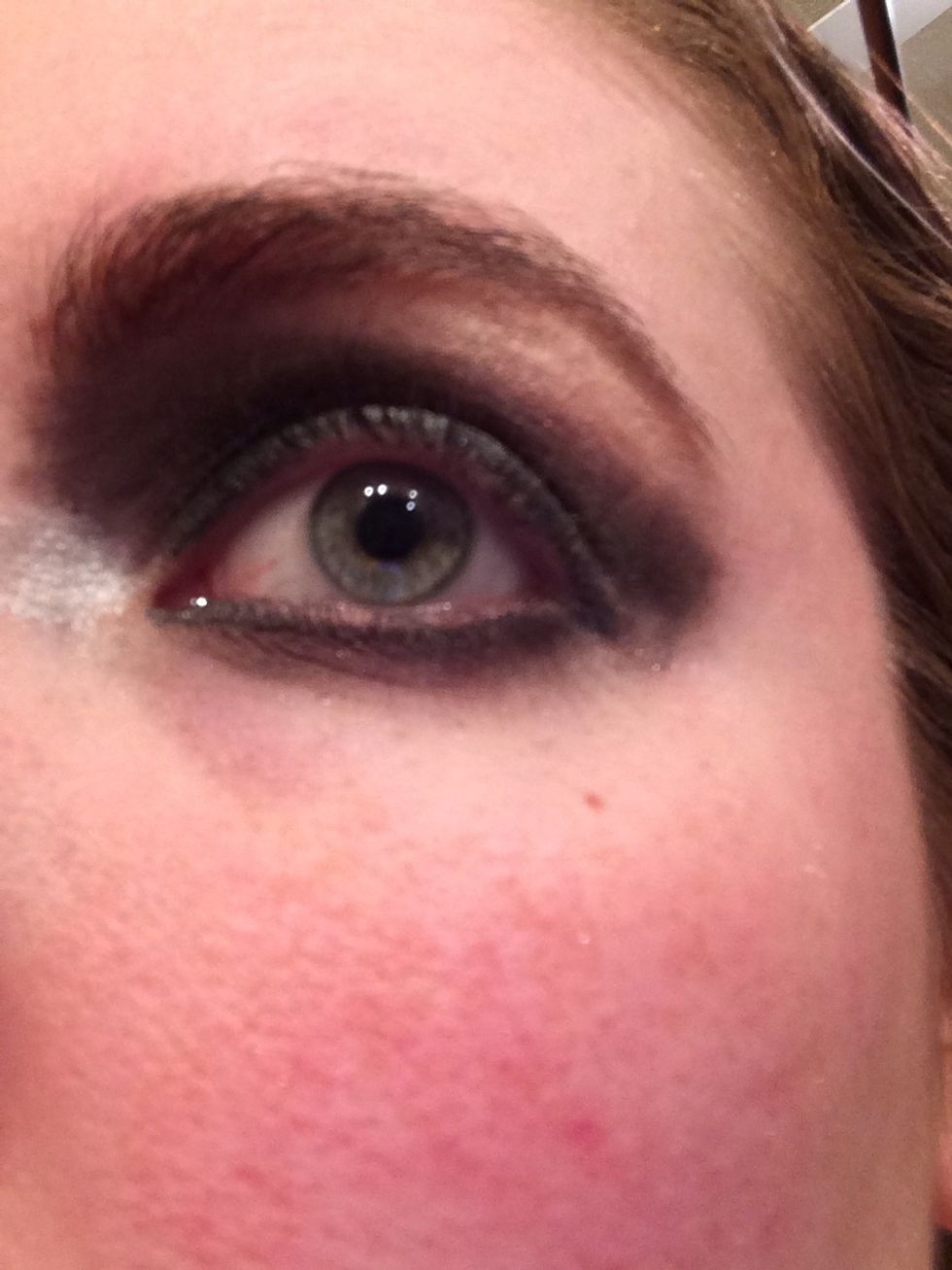 Take a regular eyeshadow brush and use the same deep eyeshadow. Smudge over the eyeliner line on your lower lid.