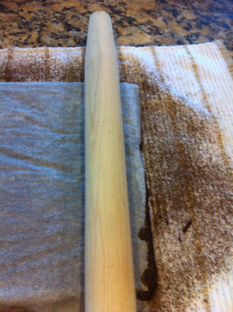 Take a rolling pin as you holder for the middle, and roll cake up