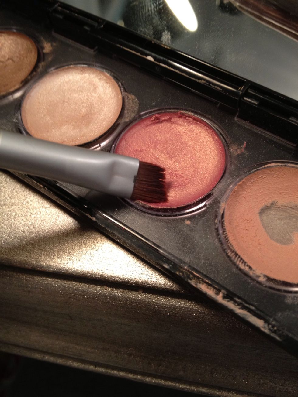 Take a rose gold eyeshadow and a small angled brush (new or clean).