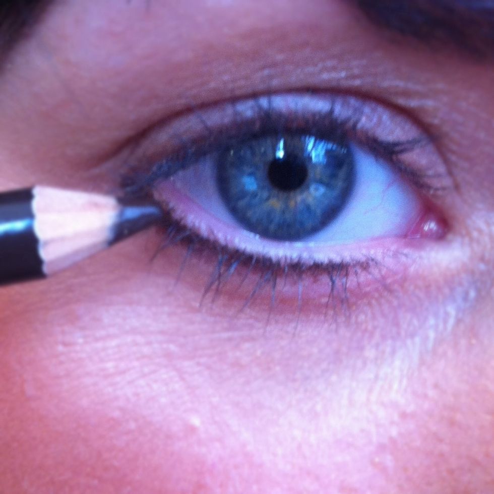 Take a sharp black eyeliner and line your bottom lash line.