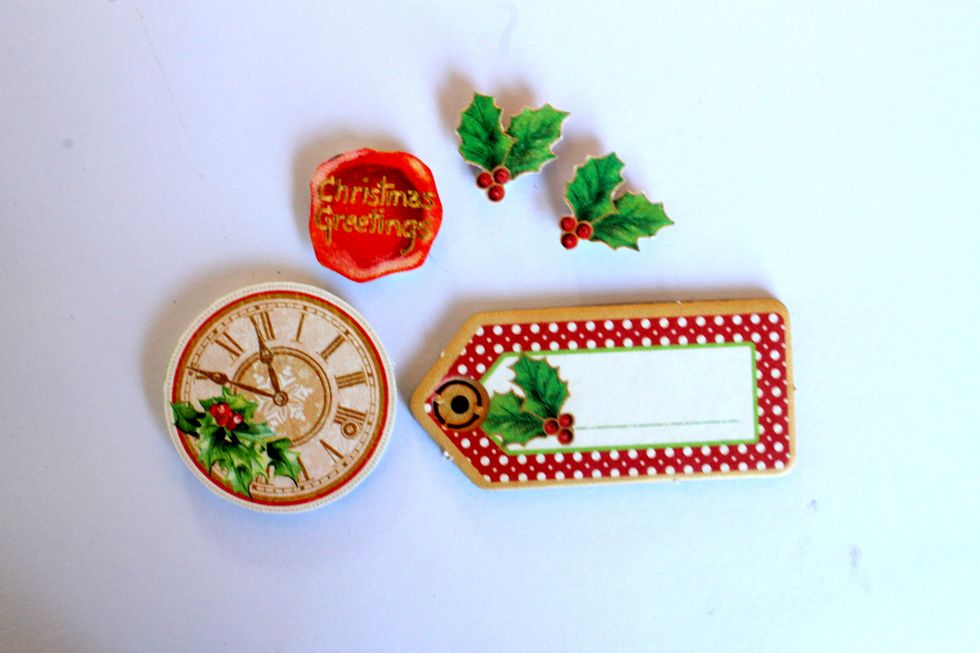 Take a small chipboard embellishment from the chipboard package. Also cut out two holly leaves, a sentiment and a clock from the Twas the Night Before Christmas papers.