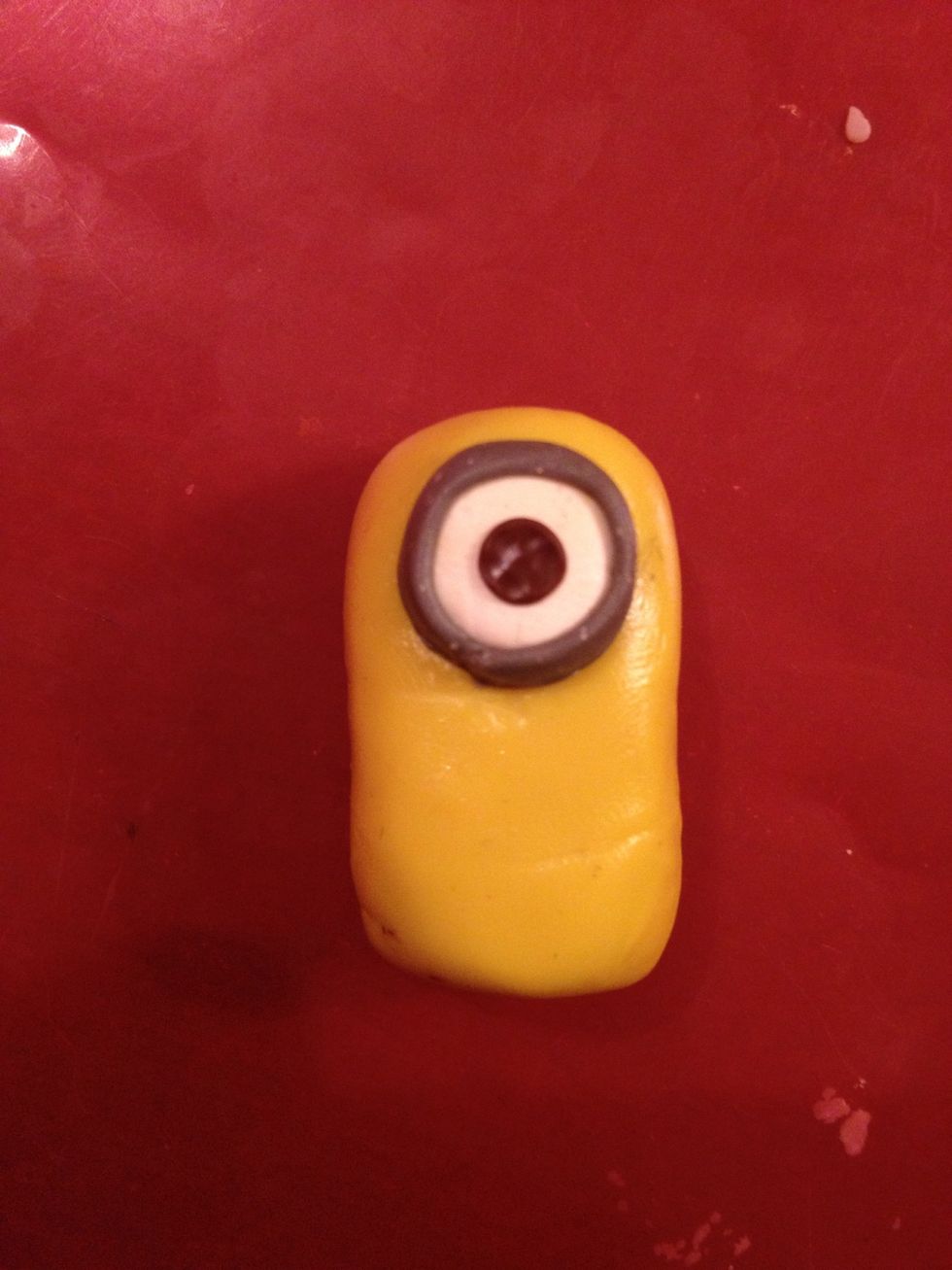 Take a small piece of brown clay and make an iris.