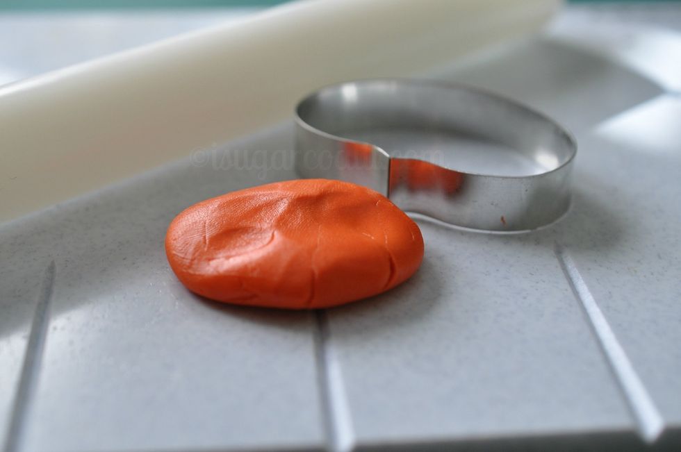 Take a small piece of the colored paste and use your rolling pin to roll out until almost paper thin over one of the grooves on the CelCakes board.