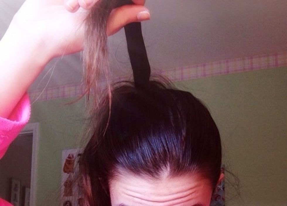 Take a small section from the ponytail and put it aside for the middle of the bow