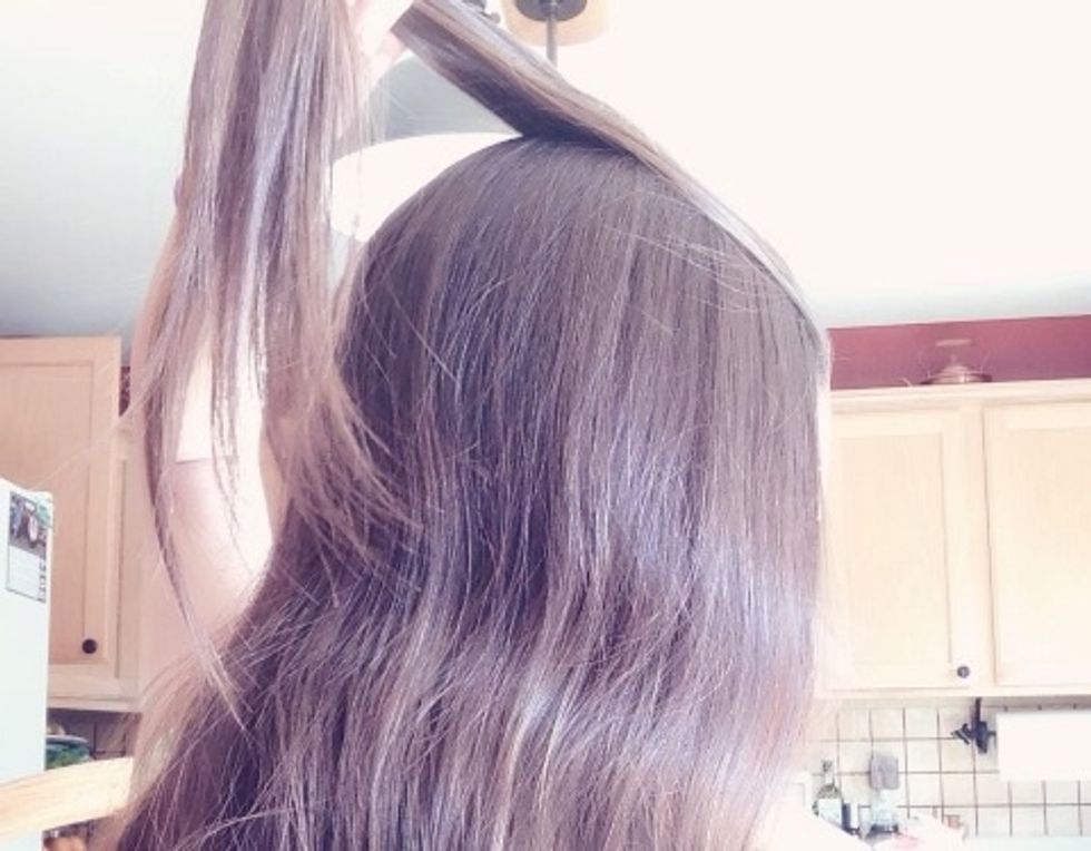 Take a small section from the top of your hair