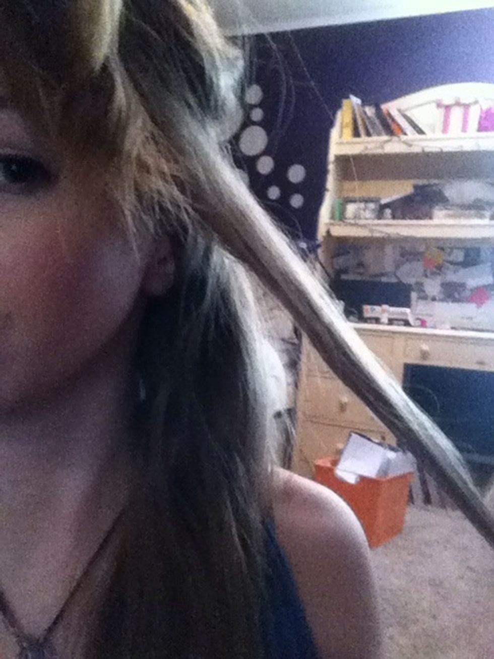 Take a small section of hair, and wrap it around your curling iron