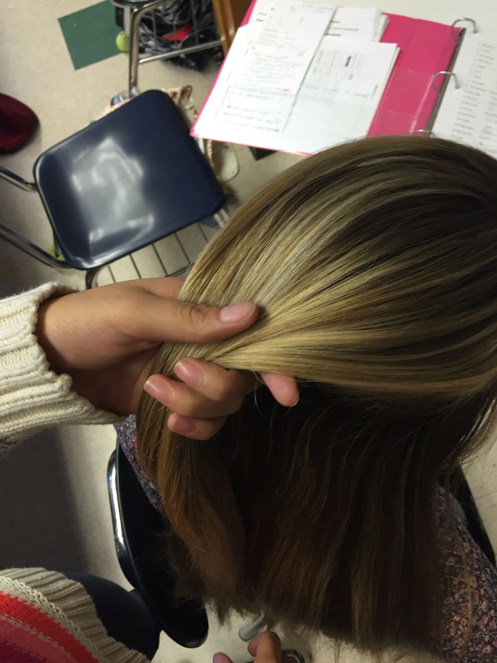 Take a small section of hair from the top