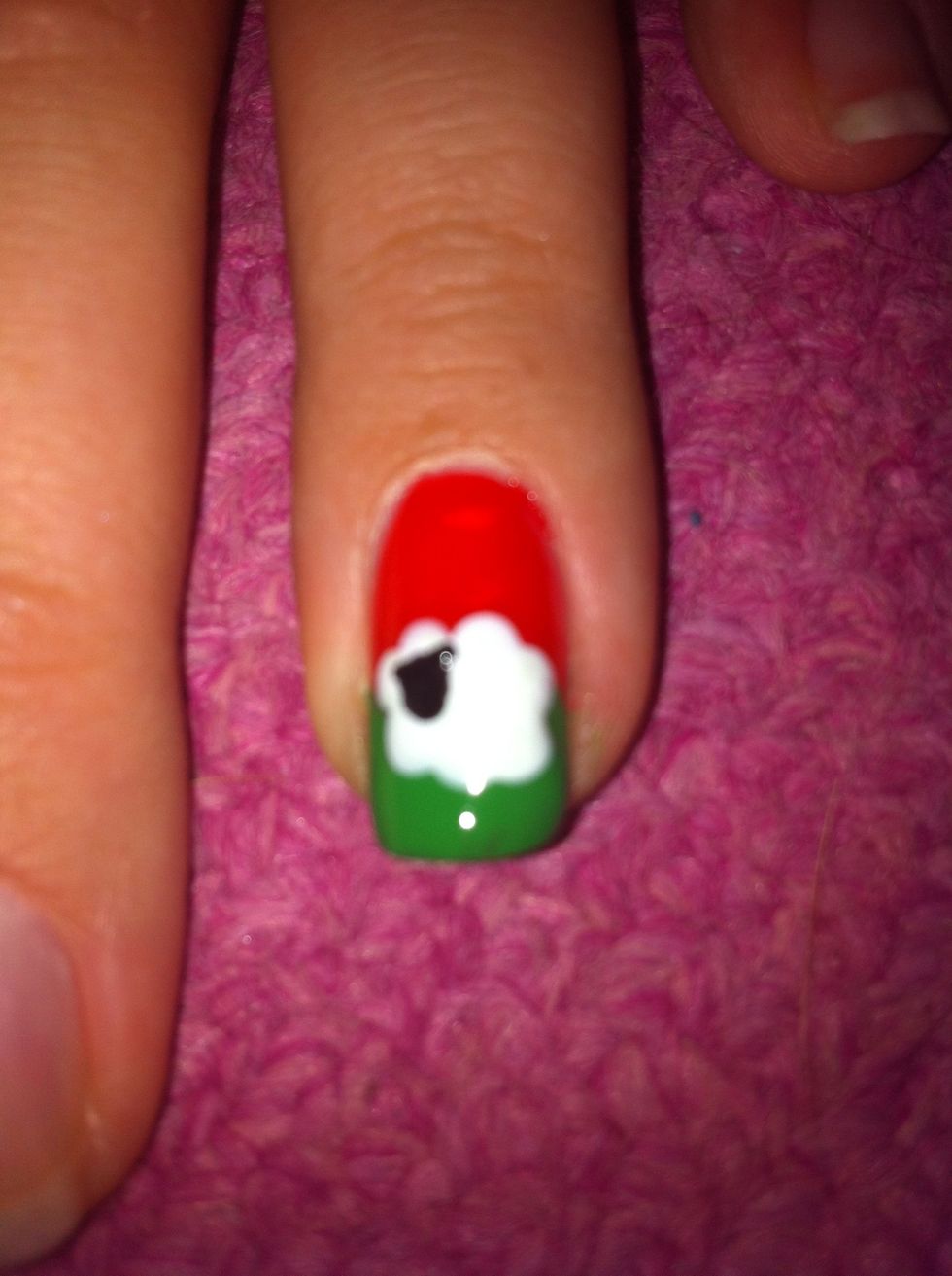 Take a smaller dotting tool, dip it into the black polish, place two small dots in either side of the head, to give the impression of ears.