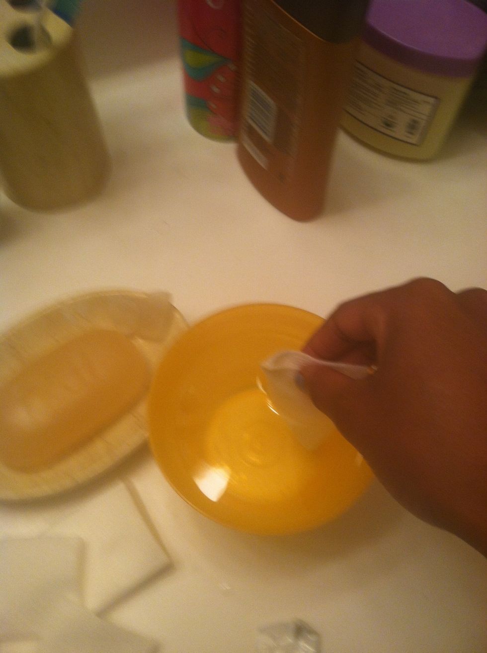 Take a sponge & dip it in the water..gently wash away the soap from the tat you will see some of the ink on the sponge don't be alarmed b/c it's still healing..repeat as needed until the soap is gone