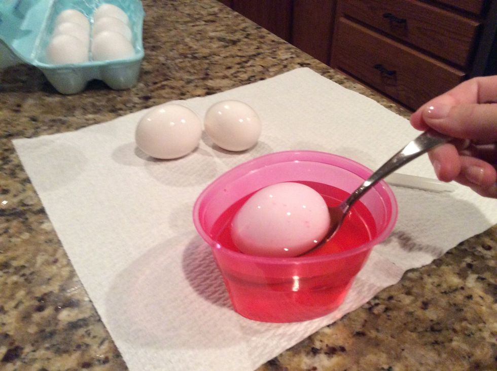 Take a spoon and occasionally dunk and move around egg till fully coated