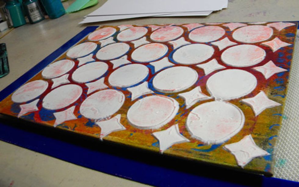 Take a stencil that will fit on top of the panel ( I used a 12x12 size stencil that I had in my stash) and add a thick layer of Mud  to the canvas panel through the stencil. Let dry completely.