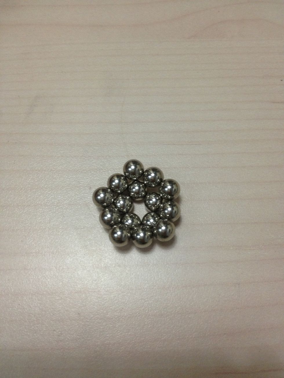 Take a strip of 10 balls and stick them around the ring of 5 balls