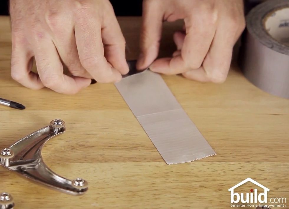 Take a strip of duct tape. With sticky side up, fold over one end, enough to label it.