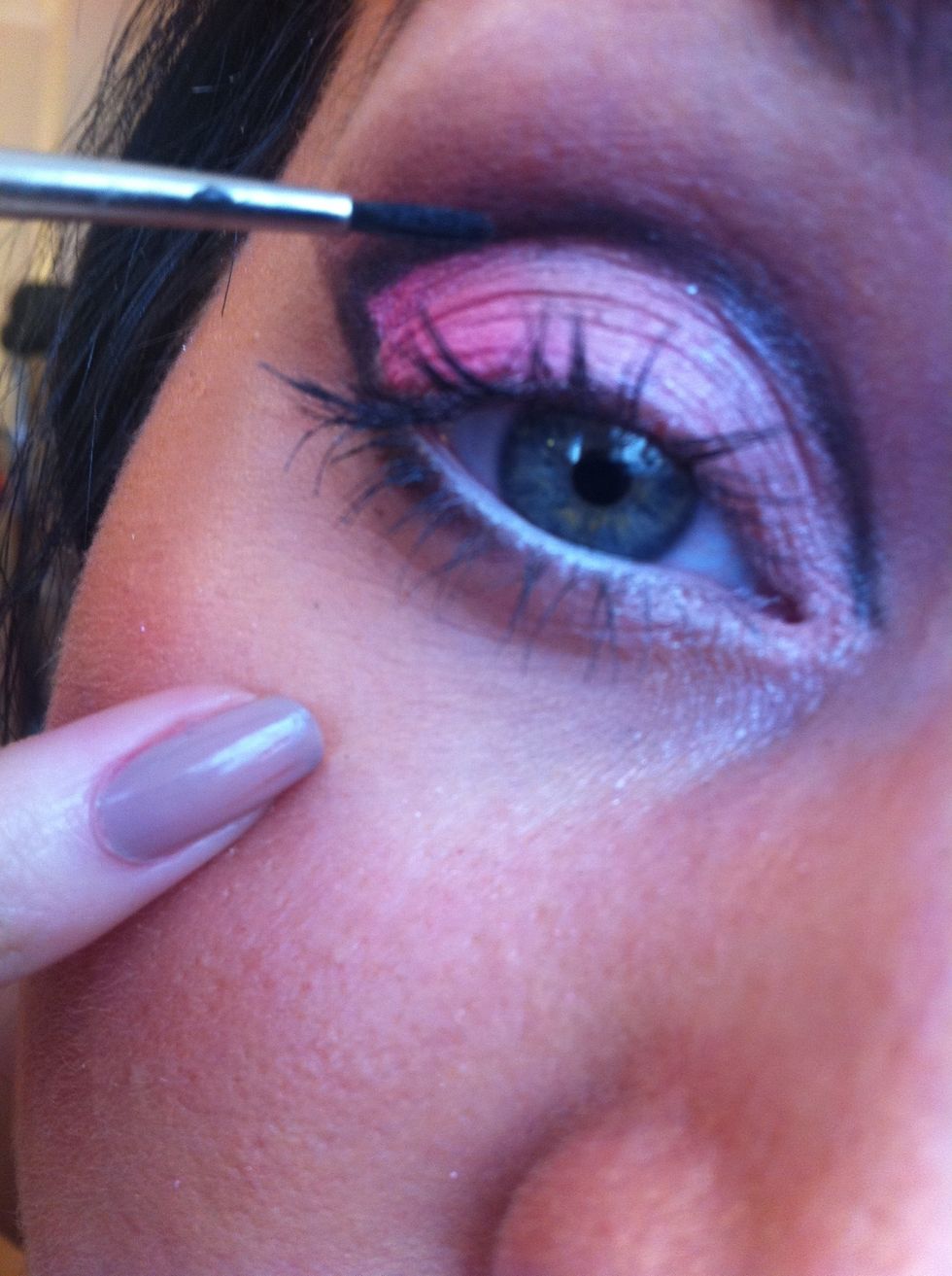 Take a thin art brush and load it with black eyeshadow to create a strong harsh crease line, keep this really neat! And extend right to the inner corner of the eye!