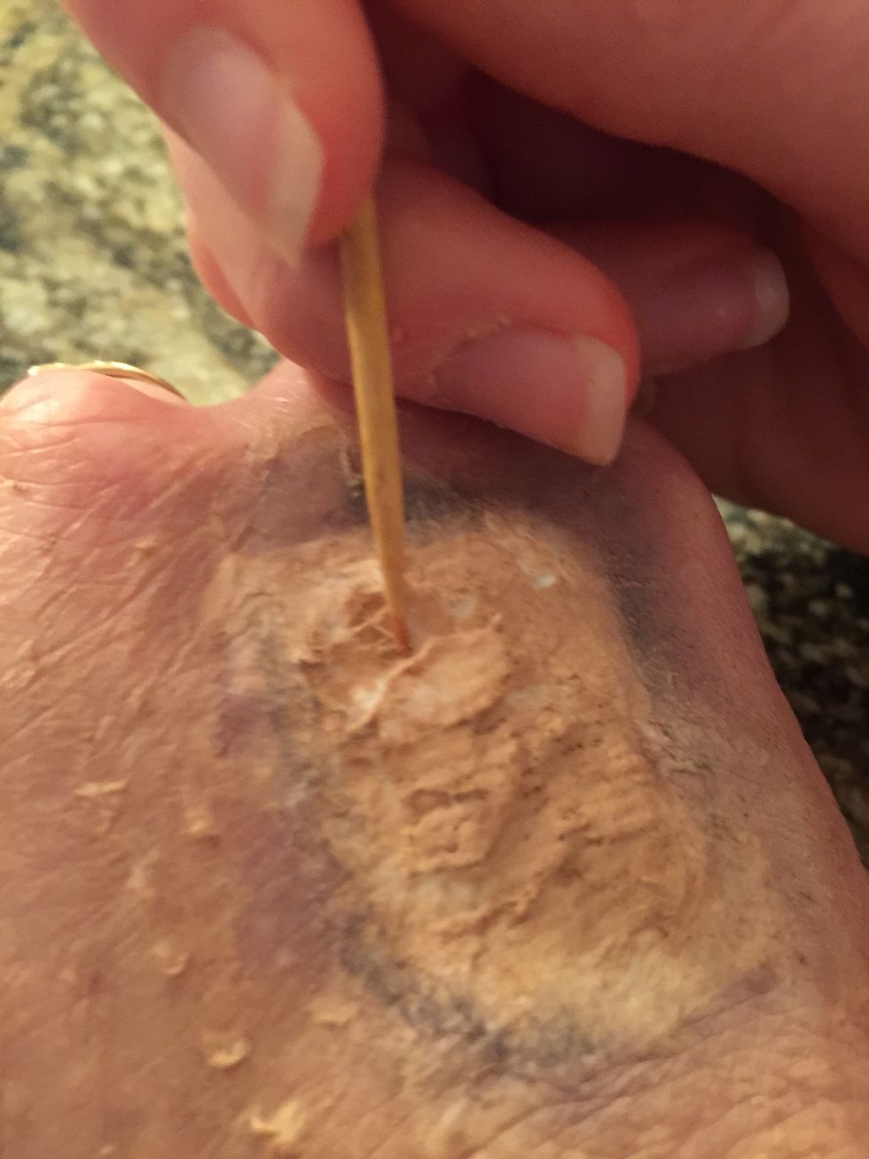 Take a toothpick, and run through the middle of the toilet paper making a slit.