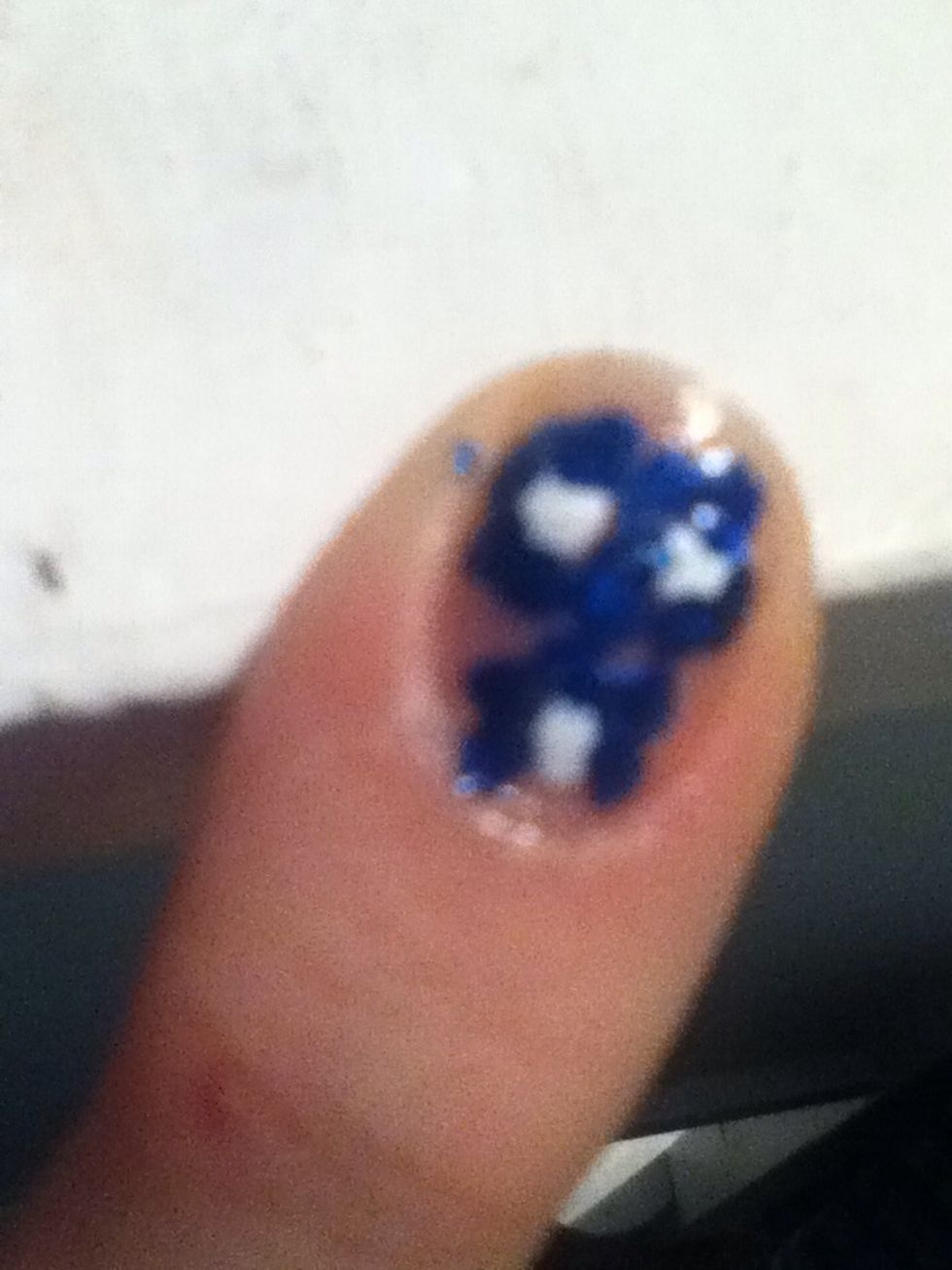 Take a toothpick or your nail design stick and blend petals around center of the flower