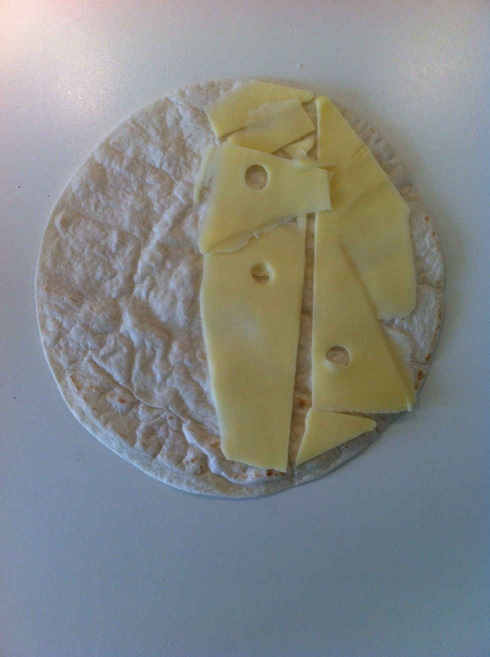 Take a tortilla bread. Put your filling on one of the sides. I only use cheese, but you could have more.