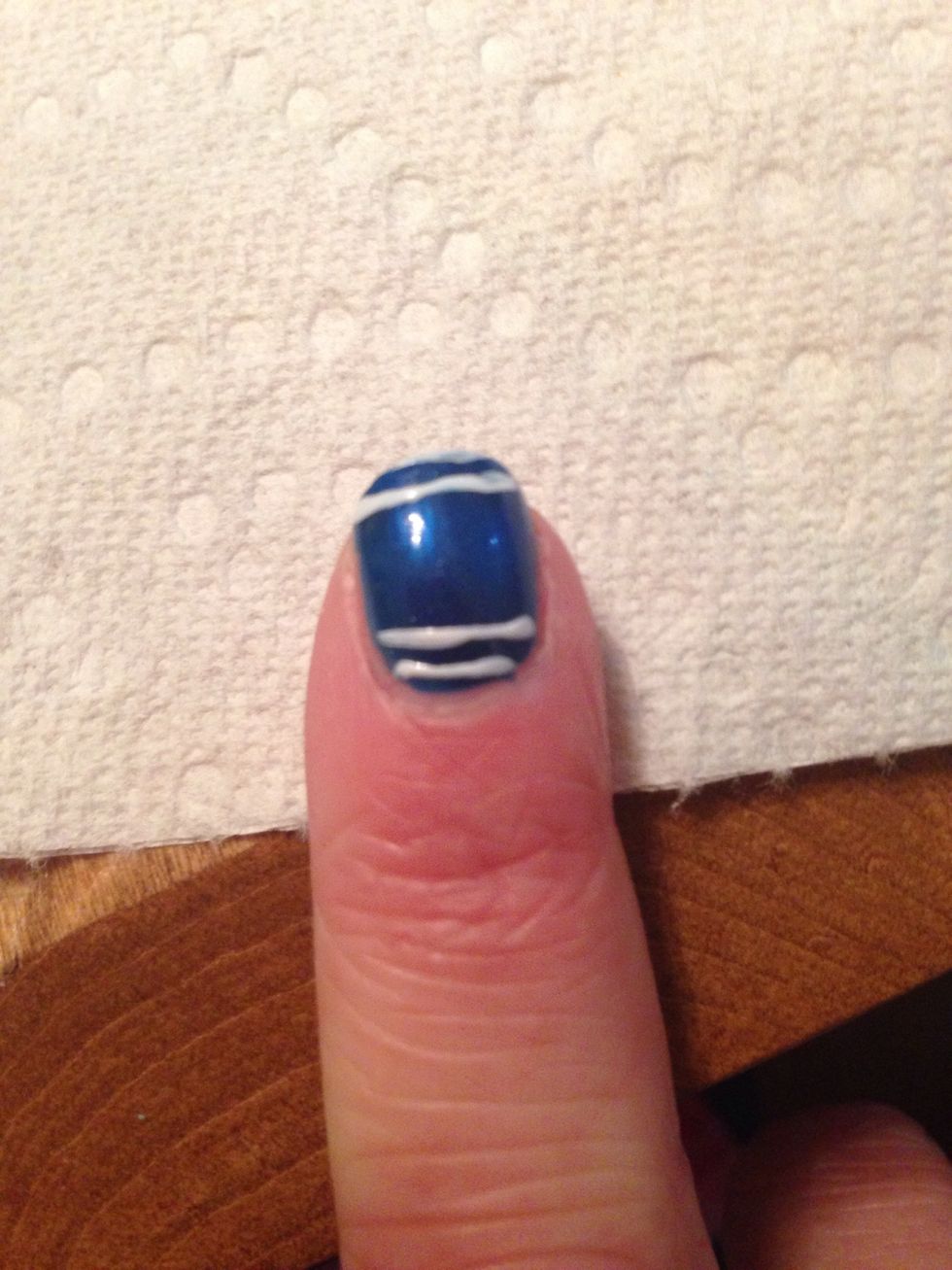 take a white striper and put 2 white lines on the end of your nail and by your cuticle