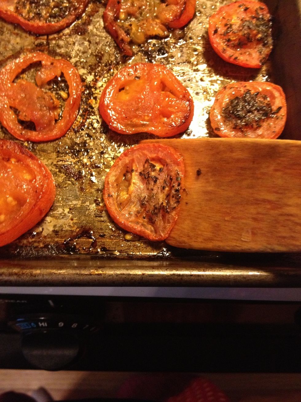 Take a wooden spatula, or any thin spatula you have, and carefully lift each tomatoe, and flip them over. "Side 1"