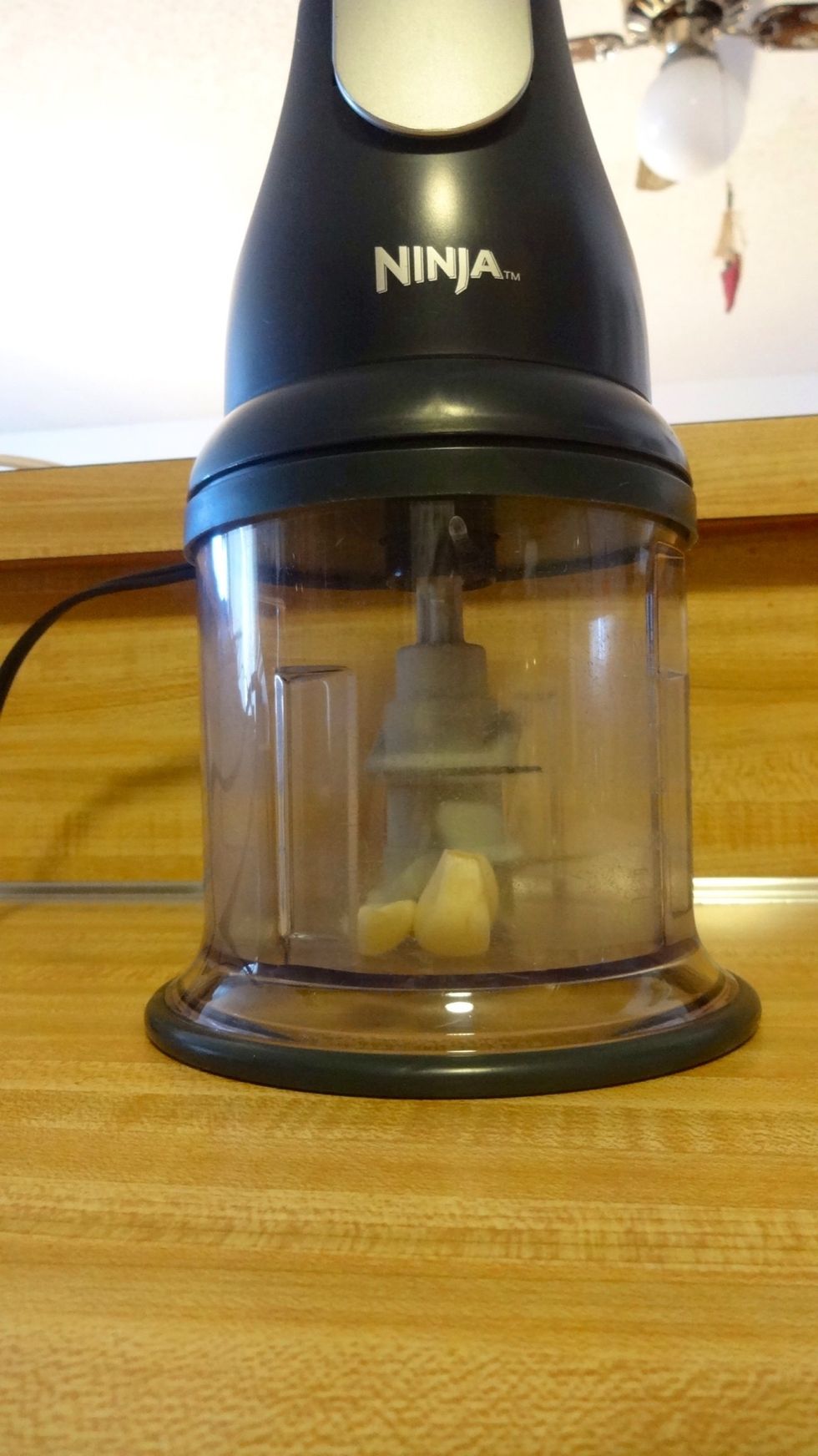 Take about 2 or 3 cloves of garlic and put them in a food processor. Now pulse until in small pieces.