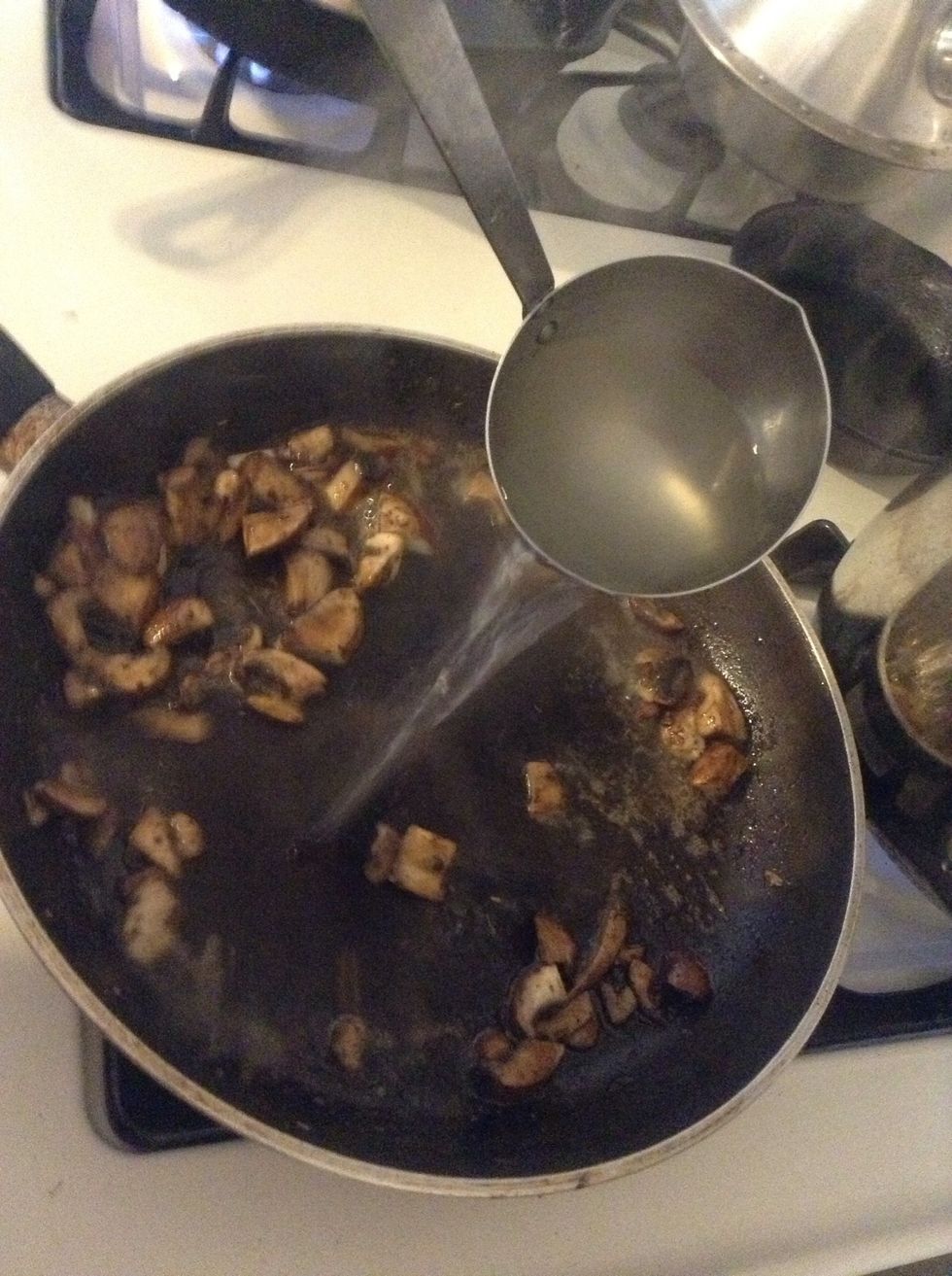 Take about half a ladle of the water the pasta is cooking in and add to the skillet.
