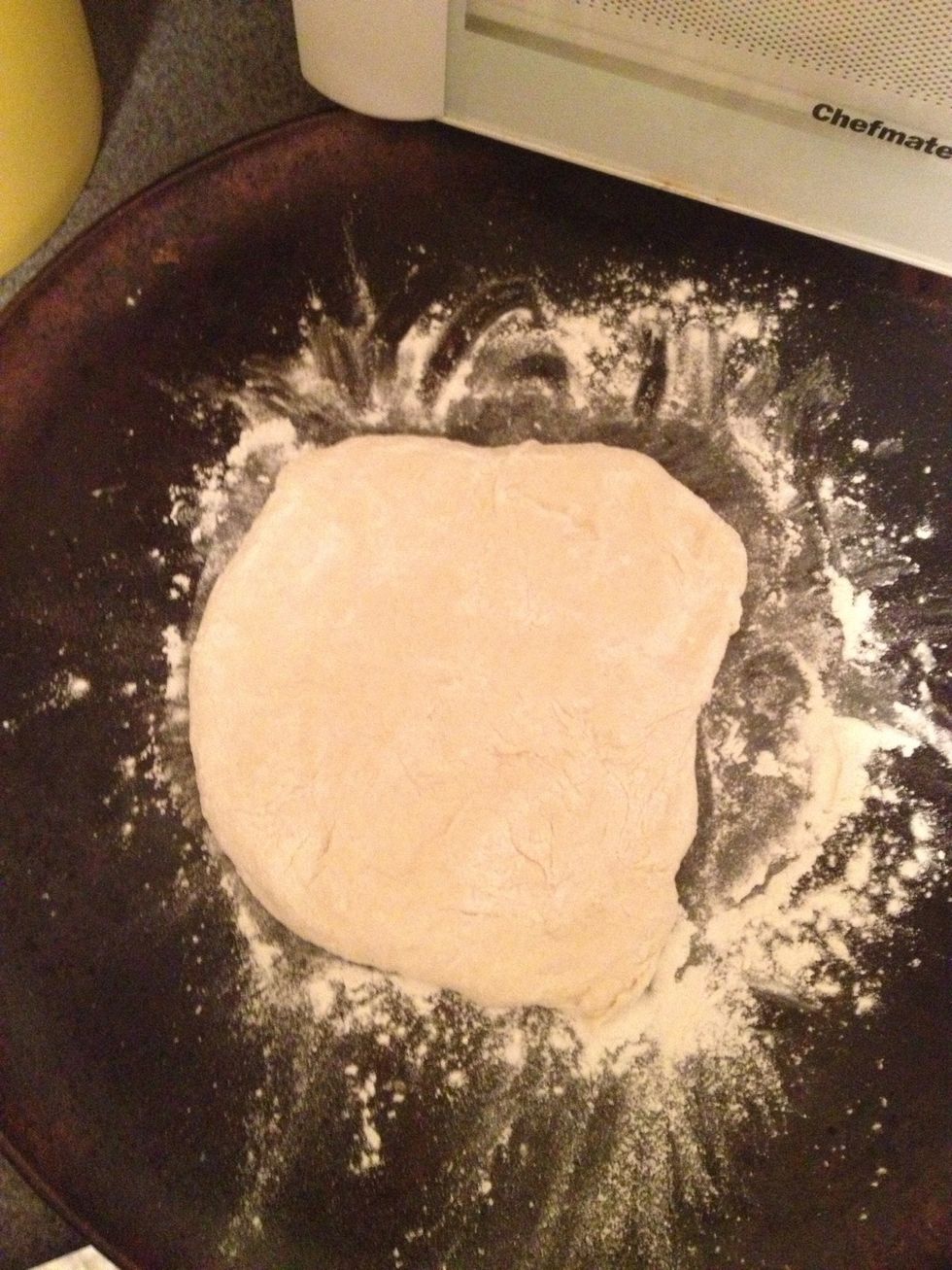 Take about half the dough and put on a well floured surface, start to form your pizza by hand