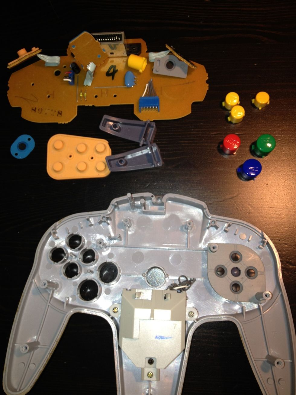 Take all the small components out of the controller, leaving the plastic casing bare.  This allows you to work easily while drilling a hole for the USB.