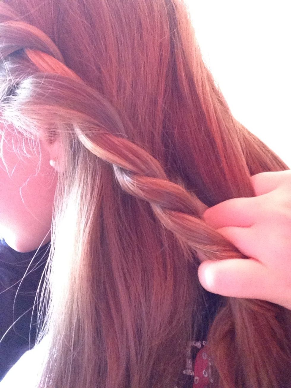 Take all your hair to the side and separate it into three pieces to start the braid. I've put the twist in the middle section but you can put it where ever you want it to be...