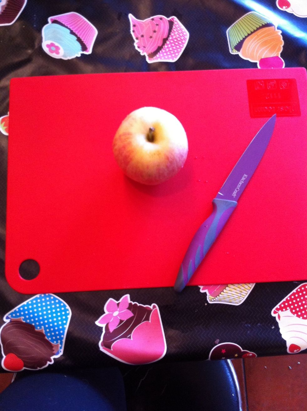 Take an apple, knife and a cutting board