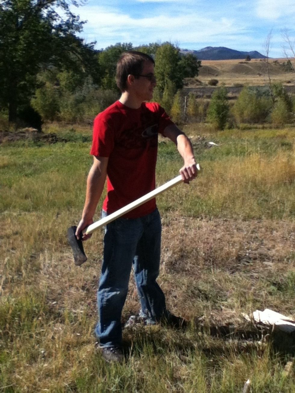 Take an athletic stance and keep your feet pointing towards the base. Hold your dominant hand towards the head of the tool. Slide it towards the non dominant on the downstroke.