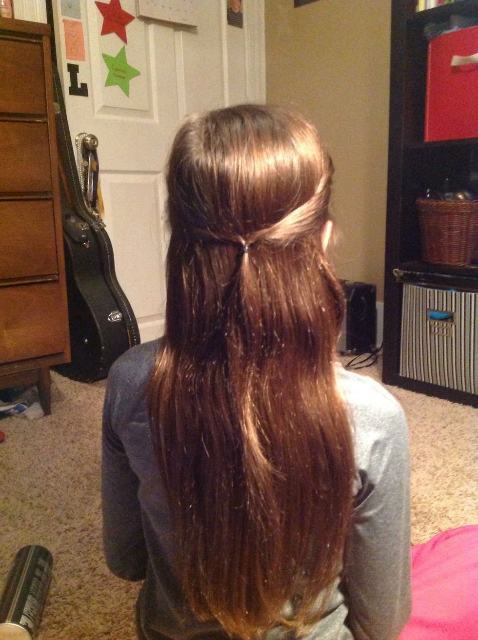 Take an inch or so of hair right above each ear, and fasten them together loosely with the hair tie.