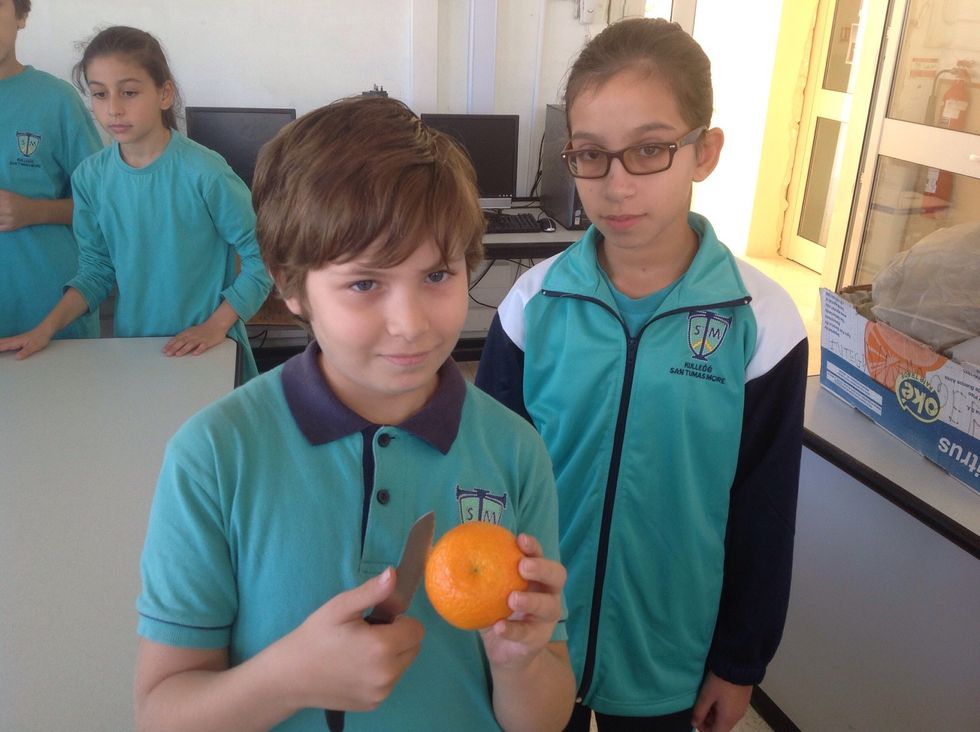 Take an orange and cut the top part of it.