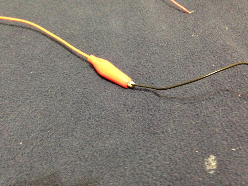 Take another battery and another alligator clip and attach it to the other end.