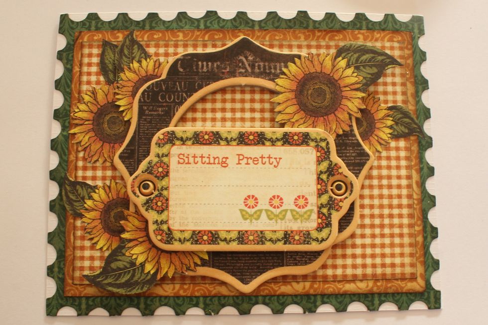 Take another chipboard embellishment from the Times Nouveau package and attach it in the middle of your card on top of the bracket-shaped chipboard piece.