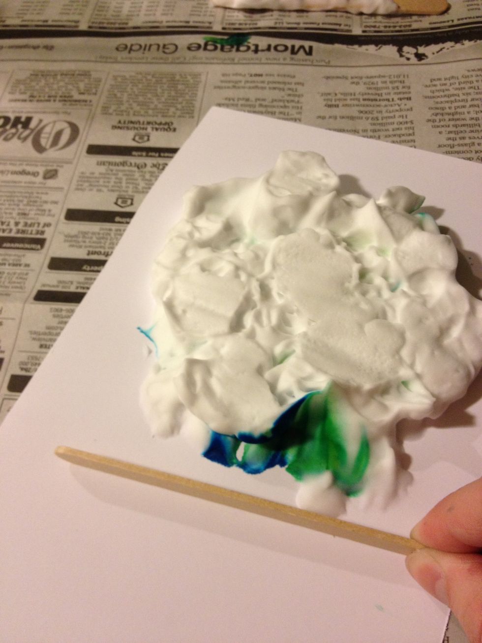 Take another clean Popsicle stick and scrape the cream off the paper\u2026