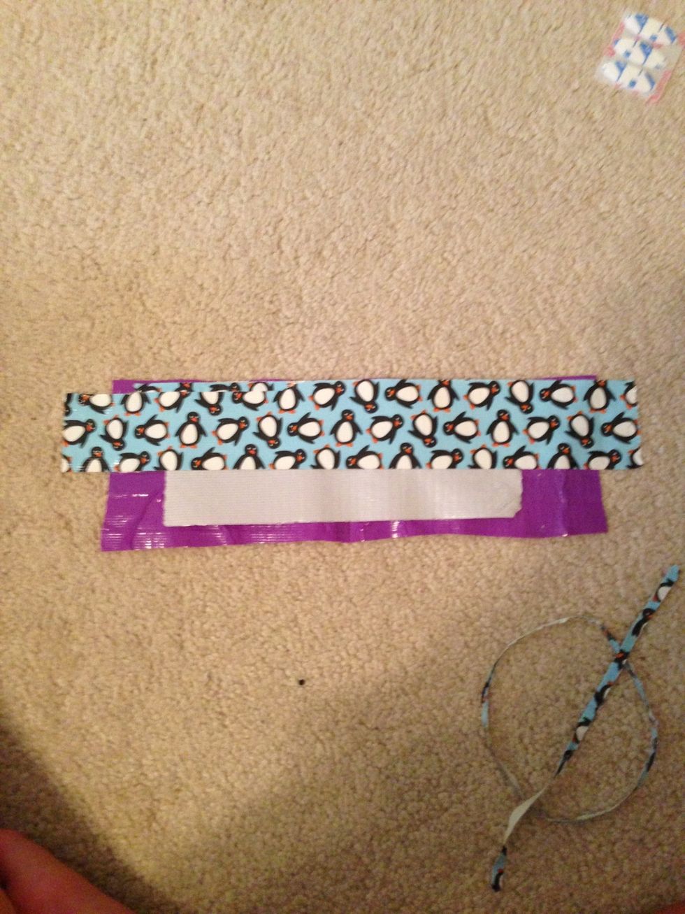 Take another color duck tape and start placing it on top
