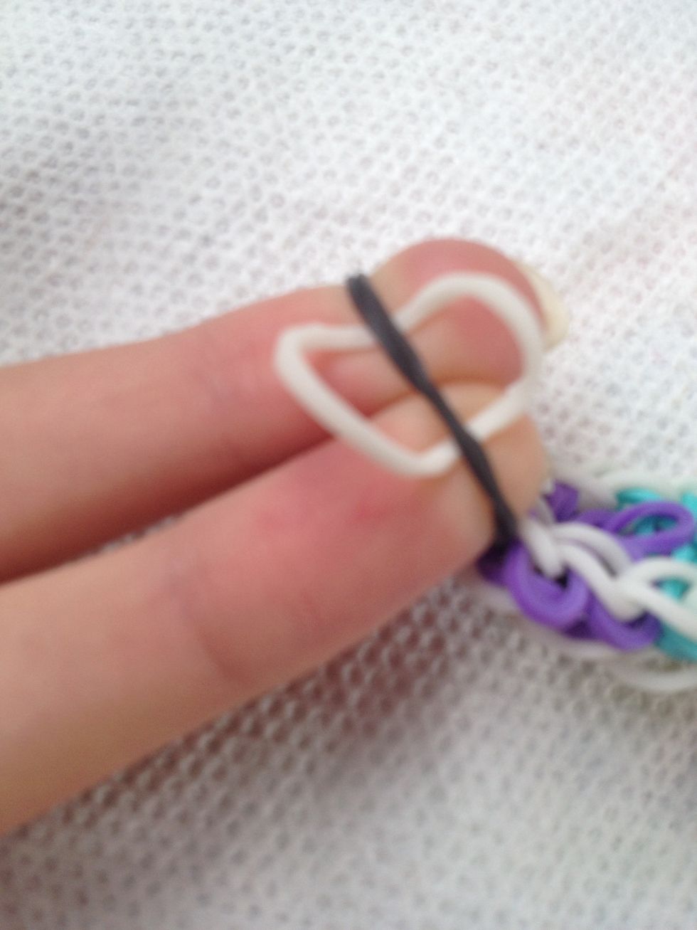 Take another rubber band and fold it under the "black" band.