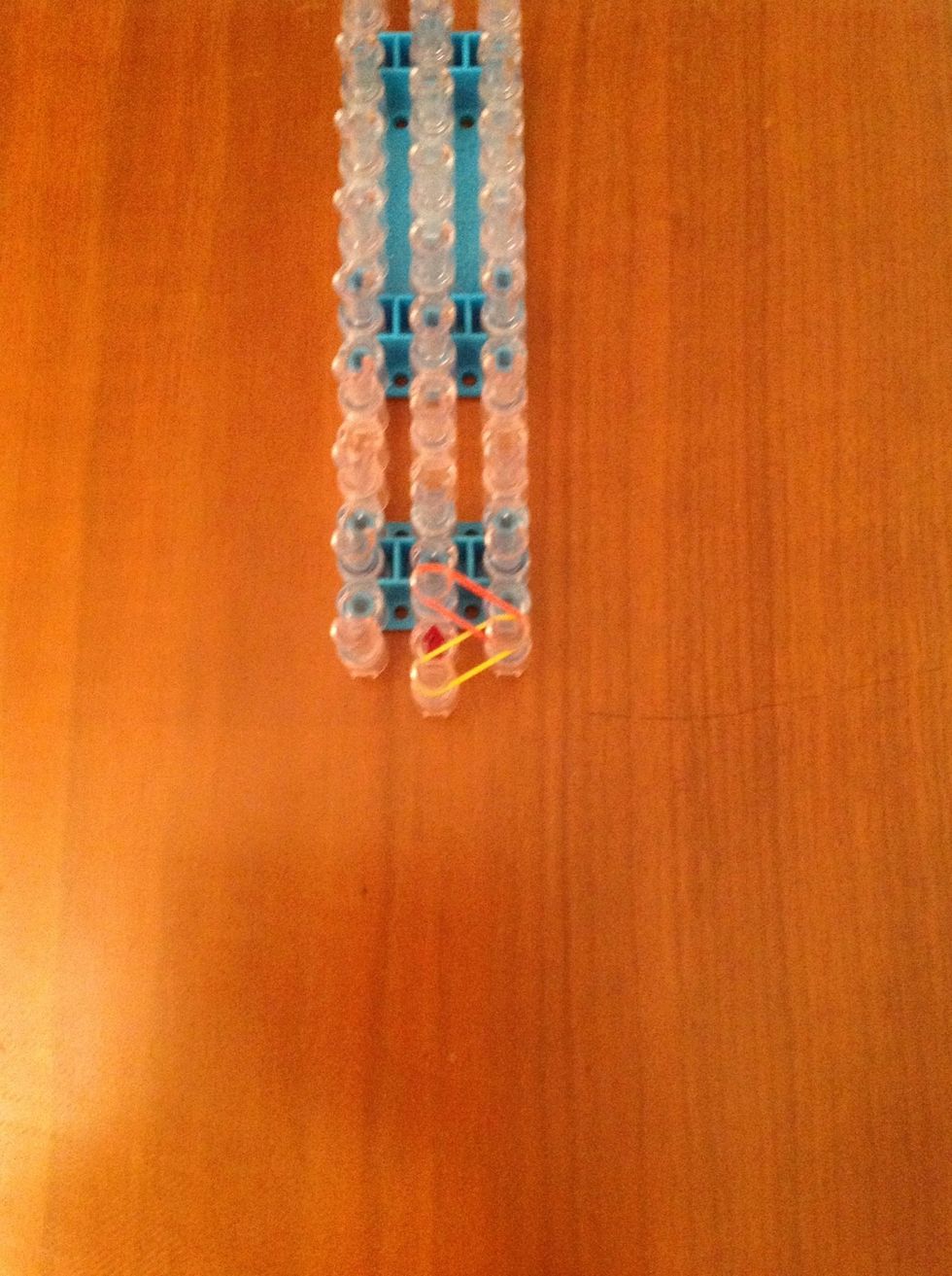 Take another rubber band and put it on the spokes so it overlaps the first on one spoke.