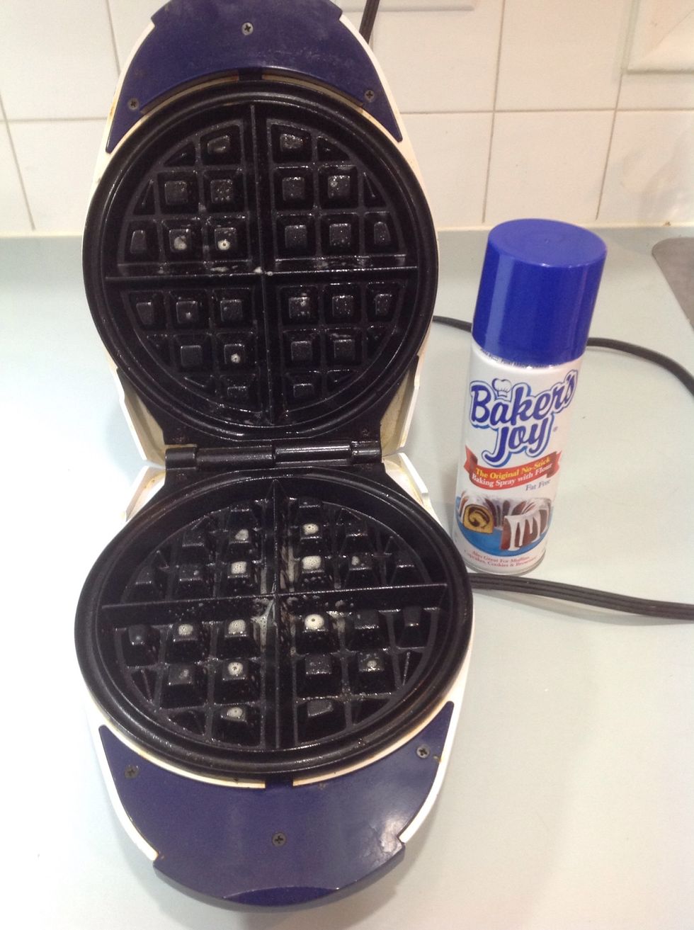 Take any nonstick spray and spray both the top and bottom halves of the waffle iron