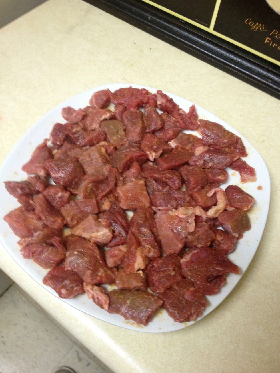 Take beef tips (labeled as "stew meat") out of the package, and place them on a large plate or pan. I used a 1.5 lb package of beef tips. Season both sides of the tips with seasoned meat tenderizer.