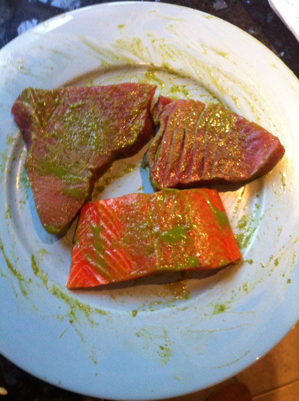 Take bit of dressing from the plate and rub into fish