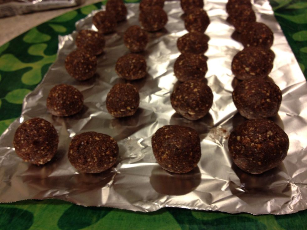 Take bits of the date mixture and roll it into balls. I rolled 24 little truffles. Put them on wax paper or foil on a tray. Then put the tray into the fridge.