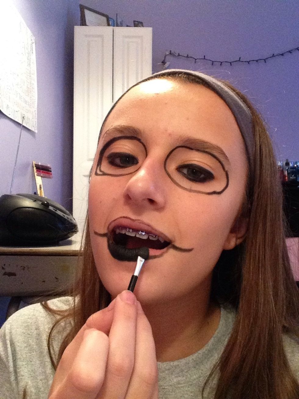 Take black eyeshadow and mat it on your lips