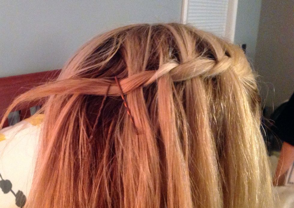 Take bobby pins and place near the end of the waterfall braid secure.