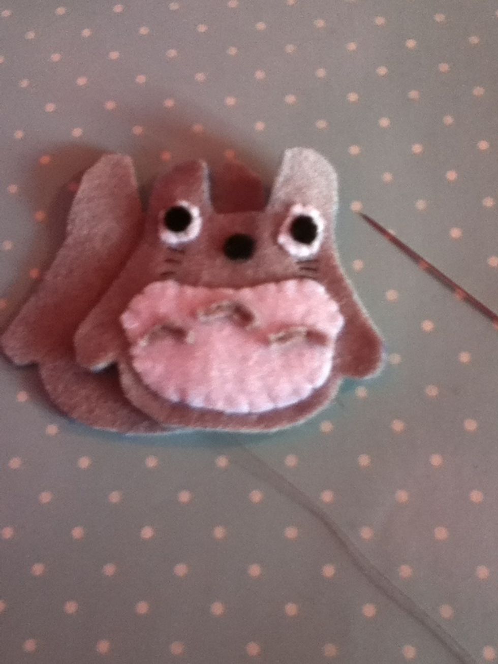Take both grey pieces and sew around the edges using a blanket stitch