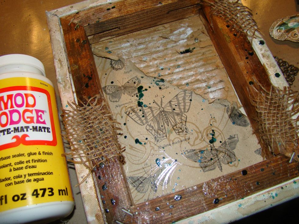 Take burlap and randomly apply to your creation using Mod Podge. Allow to dry. I also took the Glitter Glam and splattered it on the piece and dry brushed with acrylic white paint over the top.