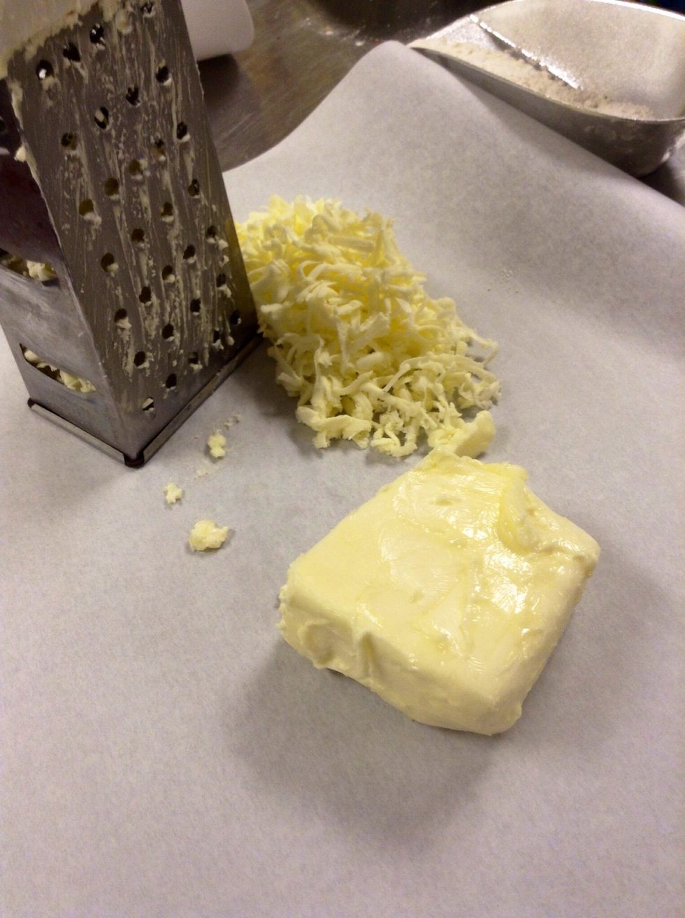 Take butter out of the fridge, make sure it's pretty cold and hard. Then Grate butter on top of wax paper.